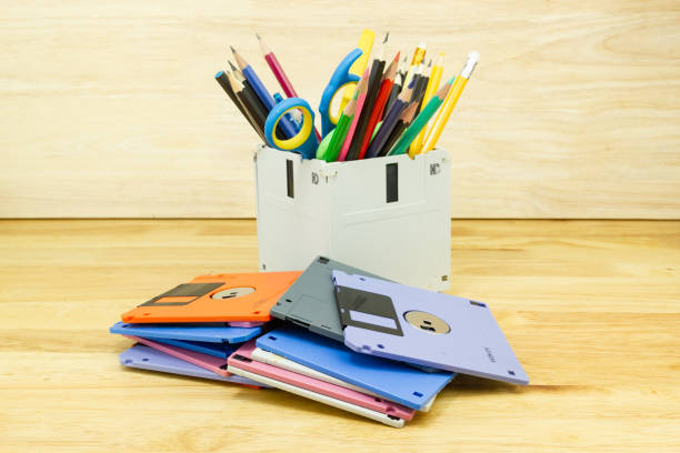 istock recycle floppy disk, Creative objects used for Store supplies such as pen pencils Scissors in a box on the table in work office, concept recycle floppy disk 1219835645