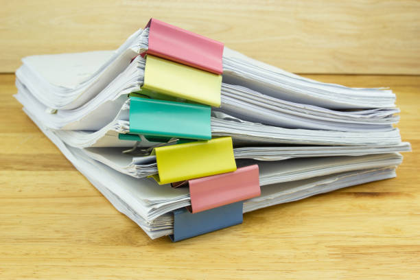 istock file folder and Stack of business report paper file on the table in a work office 1219835647