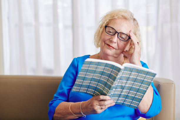 istock Senior woman reading novel 1219836783