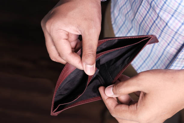 istock Empty wallet in the hands of an young man 1219836869