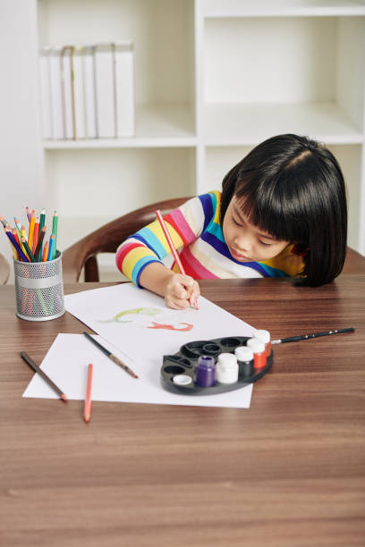 istock Girl concentrated on drawing 1219837034