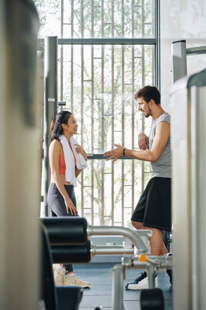 istock Couple flirting in gym 1219837070