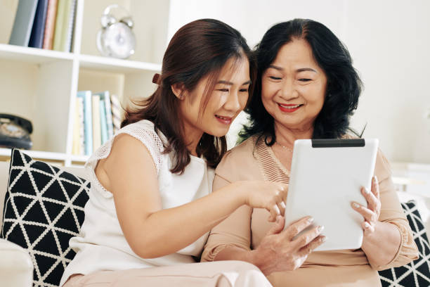 istock Mother and daughter looking at photos 1219837148