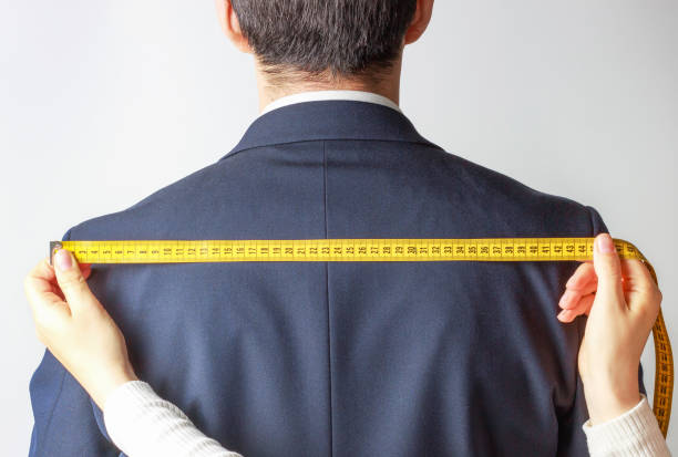 istock Women's hands measure jacket with santiment belt on a white background, back view 1219840218