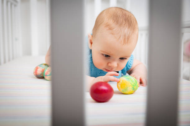 istock Baby reaching out for the egg 1219841125