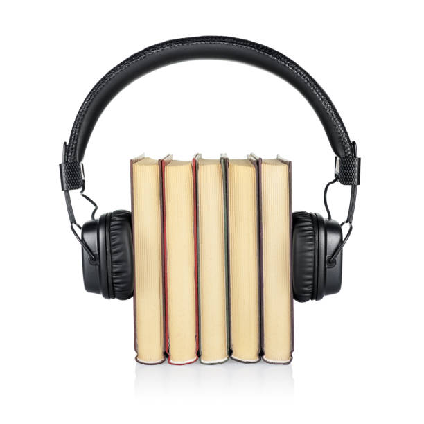 istock Audiobook concept. Stack of books and headphones isolated 1219841206
