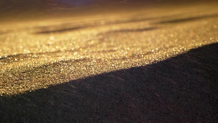 Wind waving sand in a desert. Grains flying fast. Abstract blurred slow motion shot