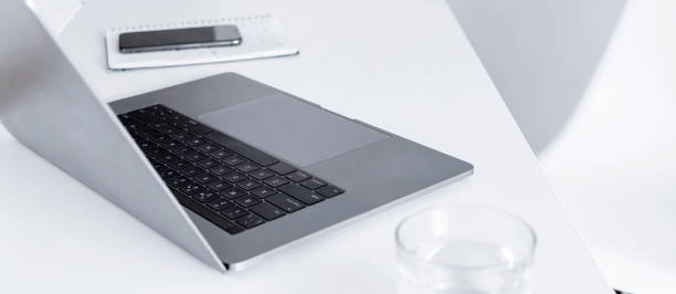 istock laptop on white office or home table Remote work or online learning concept Freelancer workspace 1219842982