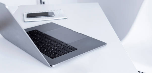 istock Home table or office desk with open laptop. Remote work or online learning concept 1219843009