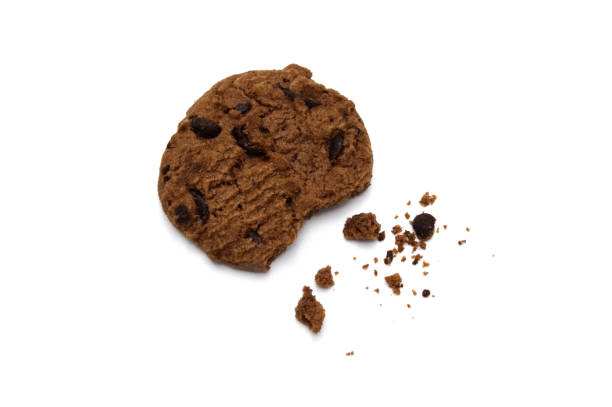 istock Chocolate chip cookies with some broken and crumbs isolated on white background. 1219844070