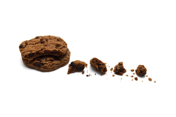 istock Chocolate chip cookies with some broken and crumbs isolated on white background. 1219844081