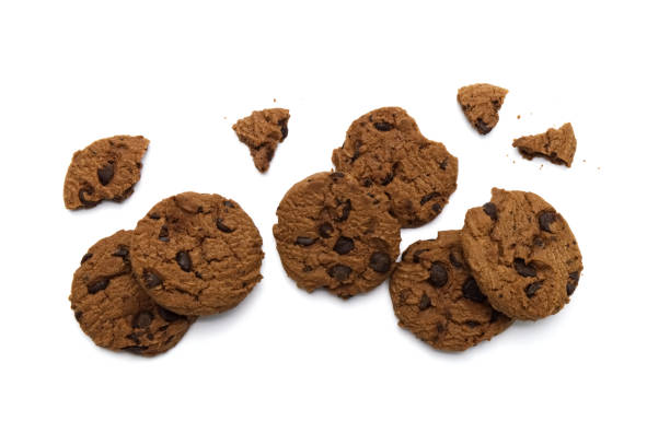 istock Chocolate chip cookies with some broken and crumbs isolated on white background. 1219844085
