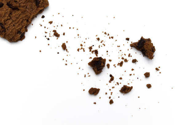 istock Chocolate chip cookies with some broken and crumbs isolated on white background. 1219844093