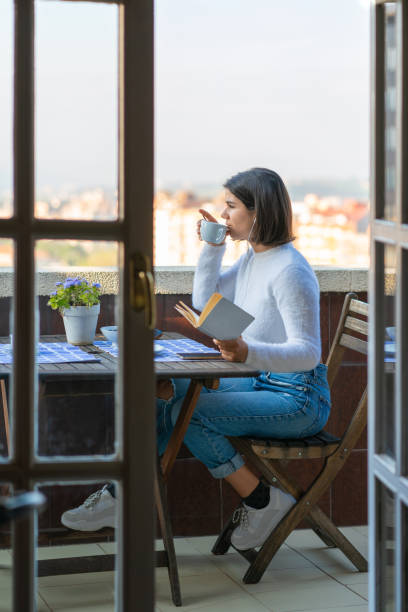 istock Woman reading a book during lockdown 1219844878