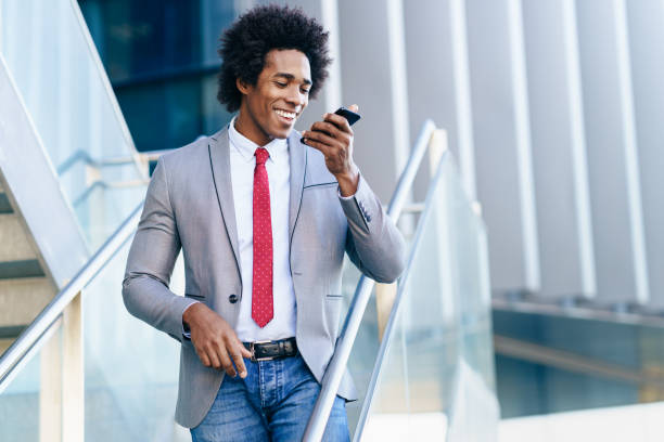 istock Black Businessman using a smartphone near an office building 1219845175