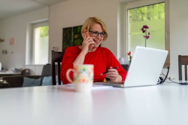 istock Woman ejoying morning coffee and working from home 1219846094
