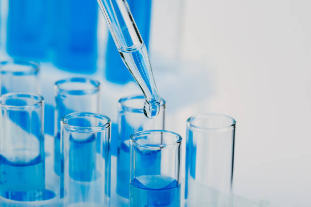 istock Laboratory glassware with a dropper dripping liquid into a test tube. scientific laboratory test tubes, laboratory equipment 1219847358