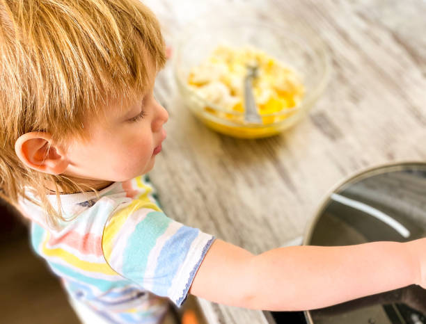 istock A fair-skinned little child in the kitchen is preparing pancakes. 1219847959