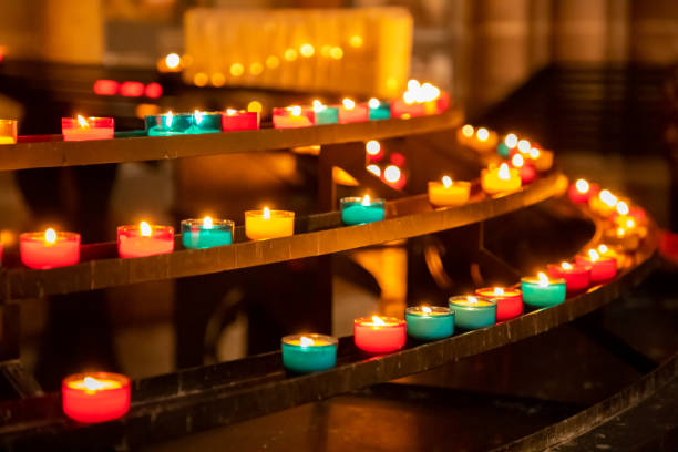 istock Colourful, burning candle lights in a church. For prayer, memory, intercession 1219848115