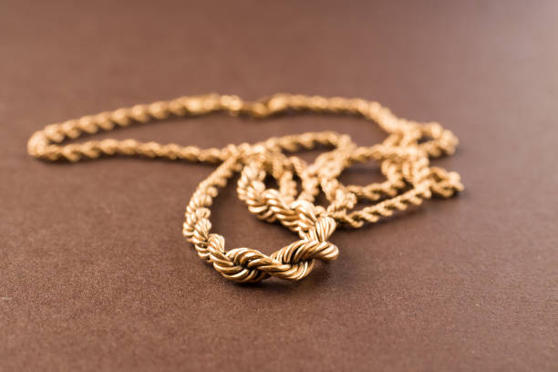 istock Gold chain on a brown background. Selective focus. Macro. 1219849203