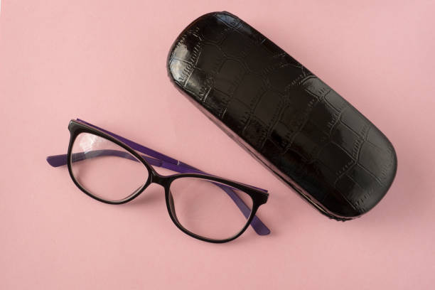 istock Glasses and black case for glasses close-up on a pink background. 1219849209