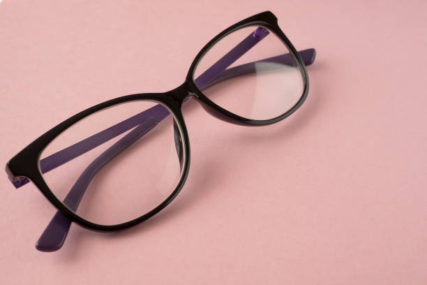 istock Glasses in black frames to improve vision are on a pink background. 1219849210
