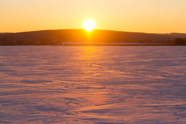 istock Sunset over snowy field 1219849358