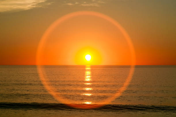 Baja California, Mexico -- A unique warm sunset on the Ocean Pacific Coast of Mexico in Baja California, with an incredible circular refraction effect due to the presence of humidity in the air.