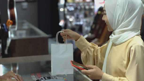 istock Asian Muslim Woman Using Contactless Payment 1219850275