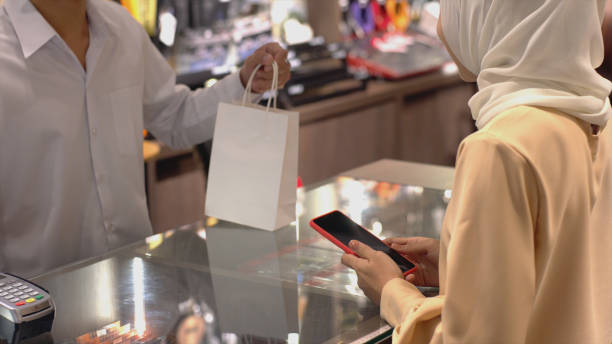 istock Asian Muslim Woman Using Contactless Payment 1219850331