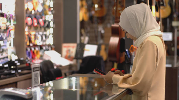 istock Asian Muslim Woman Using Contactless Payment 1219850405