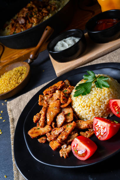 istock bulgur with fried meat and yoghurt sauce 1219850574