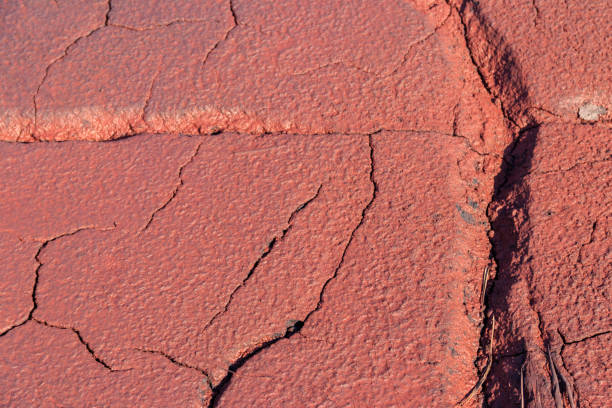 Texture of red wet ground polluted with iron ore waste