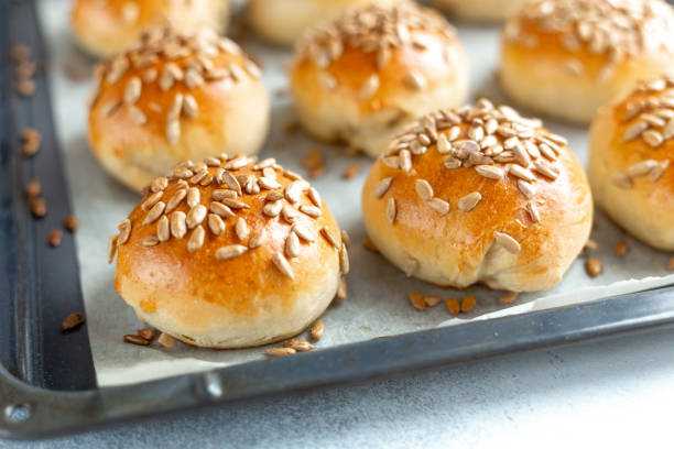 istock Hot fresh homemade buns sprinkled with seeds. Close-up, selective focus 1219852940