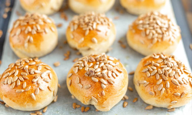 istock Hot fresh homemade buns sprinkled with seeds. Close-up, selective focus 1219853002