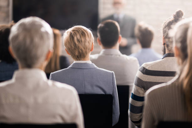 istock Back view of business people attending a training class in board room. 1219853550