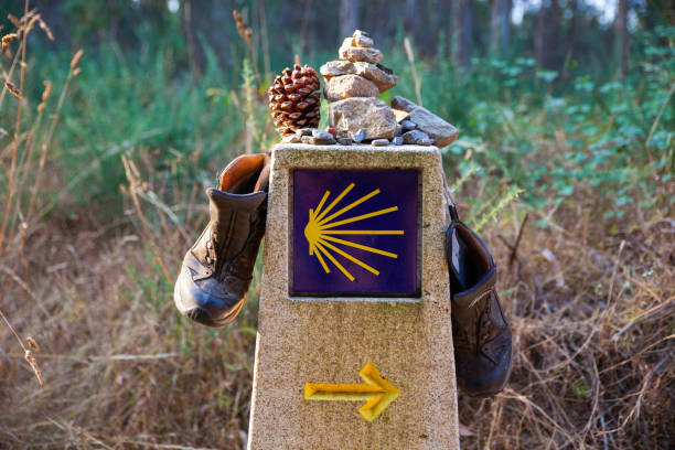 Symbol of the way of St. James Hiking boots and stone on the stone signal, Symbol of the way of St. James camino de santiago photos stock pictures, royalty-free photos & images