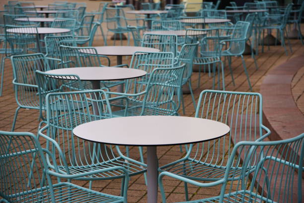 istock empty coffee house chairs without upholstery at round tables 1219855519