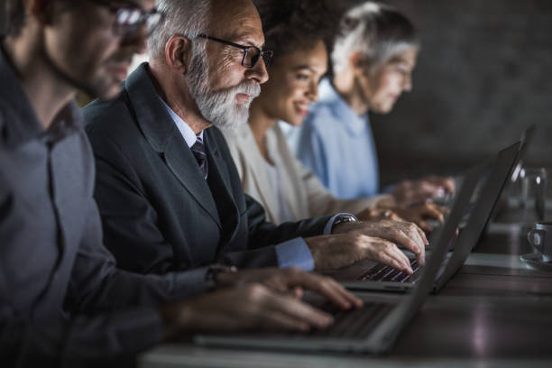 istock Group of business people working on computers late in the office. 1219856440