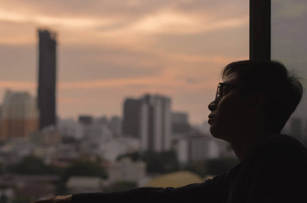 istock The man looking out at city view from the room. 1219856596