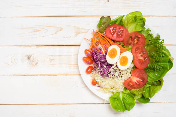 istock Vegetables Salad on white  wooden  background 1219858055