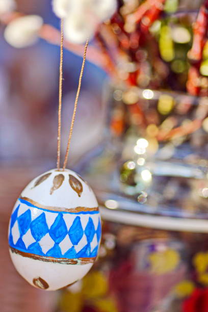 Bavaria, Germany. Easter customs - Hand painted egg and Catkins (Salix caprea) as background.