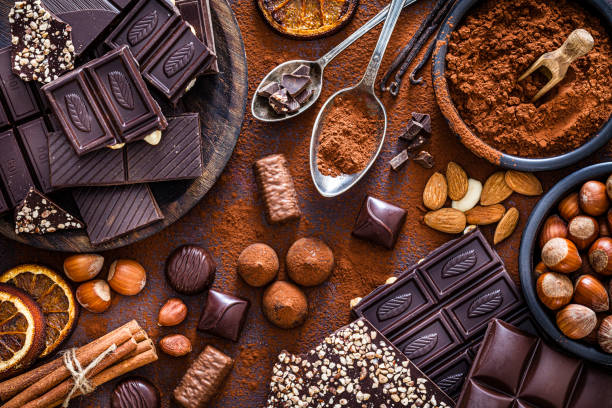 istock Chocolate bars, cocoa powder, truffles and nuts shot from above 1219858555