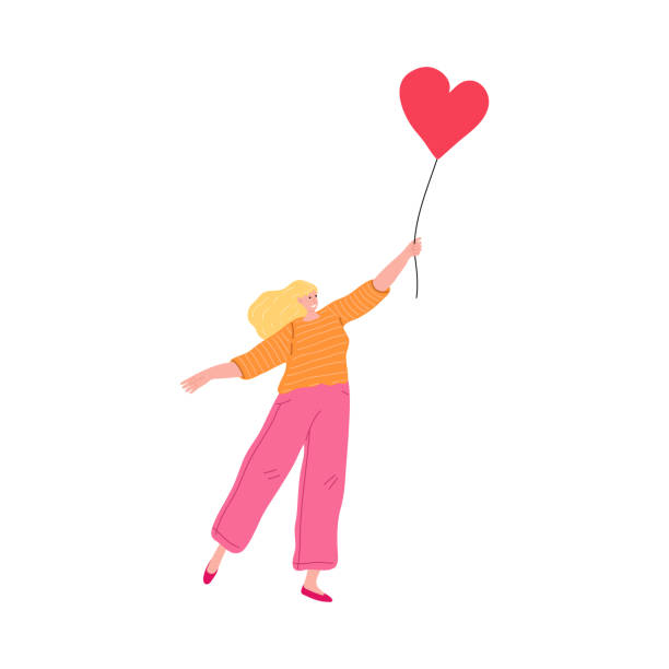 istock Young girl holding red hearts shaped balloon and expressing love 1219859280