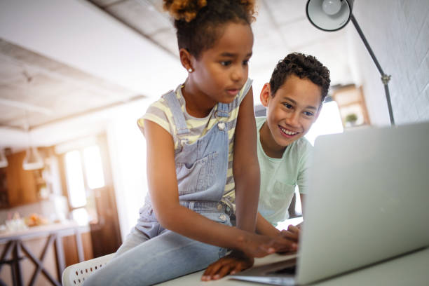istock Game, study, fun concept. Happy children spending time with notebook and modern technology. 1219859504
