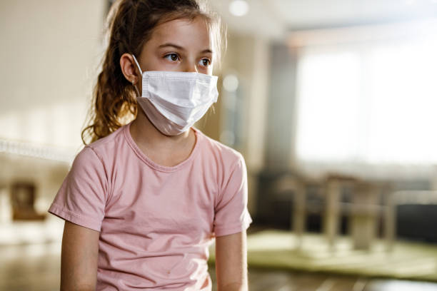 istock Little girl with face mask during home isolation. 1219859905