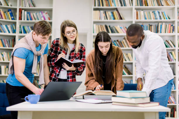 istock Female and male multiethnic students study in the college library. Learning and preparing for exam. Education concept. 1219859987