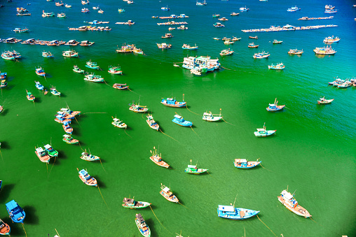 many multi-colored, beautiful boats in the sea. there are many floating boats in turquoise water, panoramic shots from the air.
