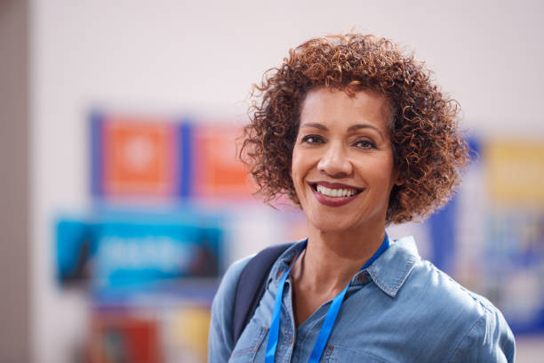 portrait of mature female teacher or student in college hall - night school imagens e fotografias de stock