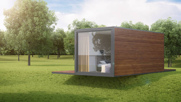 istock House from a construction transport container sheathed by boards against the background of nature. 3D rendering. 1219861254